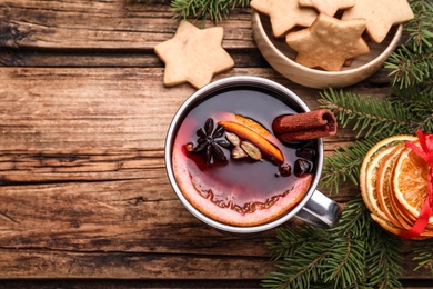 Photo of Flat lay composition with aromatic mulled wine on wooden table, space for text