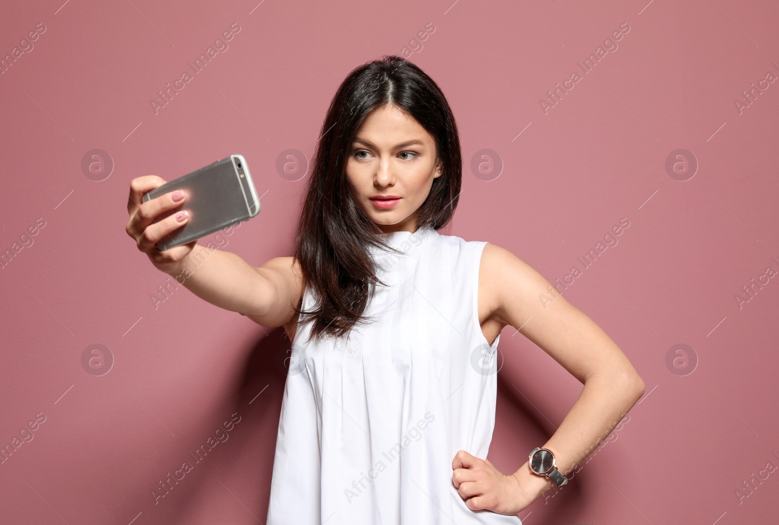 Photo of Attractive young woman taking selfie on color background