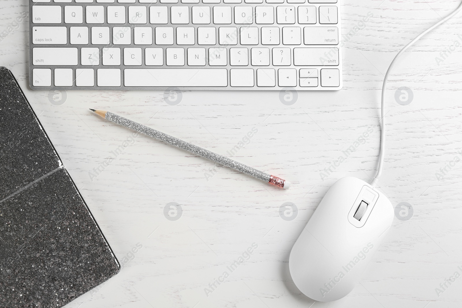 Photo of Flat lay composition with mouse and keyboard on white wooden table