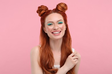 Photo of Portrait of happy woman with bright makeup on pink background