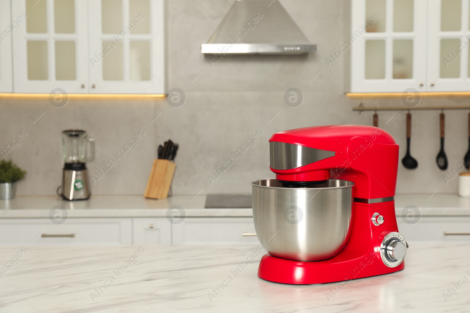 Photo of Modern red stand mixer on white marble table in kitchen, space for text