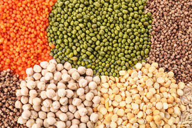 Photo of Different grains and cereals as background, top view