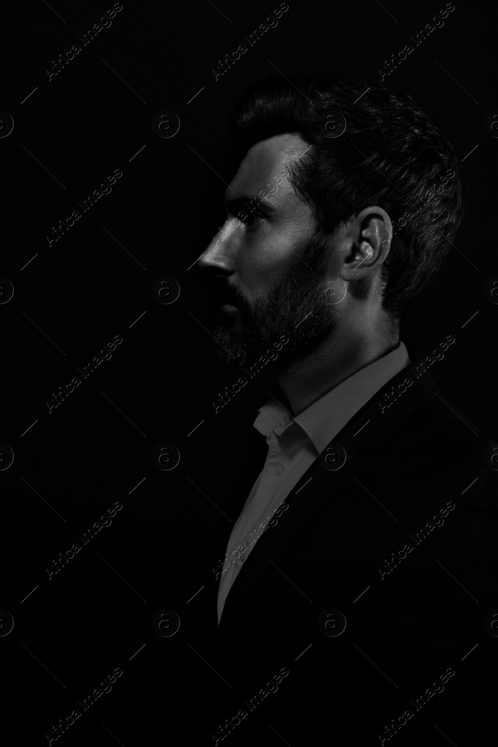 Image of Silhouette of man in darkness. Portrait on black background