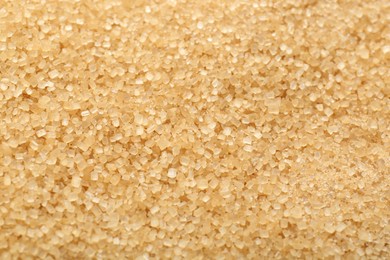 Photo of Granulated brown sugar as background, top view