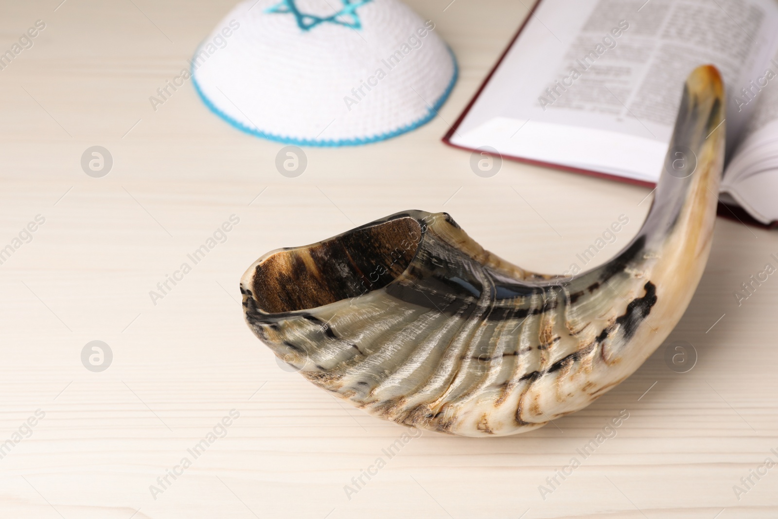 Photo of Composition with Rosh Hashanah holiday symbols on light beige wooden table