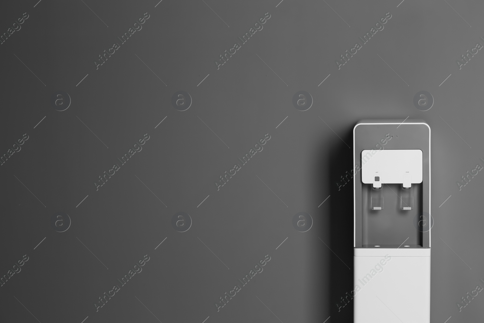 Photo of Modern water cooler against gray background with space for text