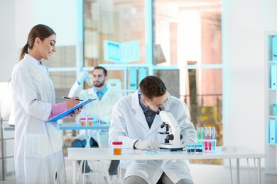 Photo of Young scientists working in laboratory. Chemical analysis