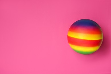 Photo of New bright kids' ball on pink background, top view. Space for text