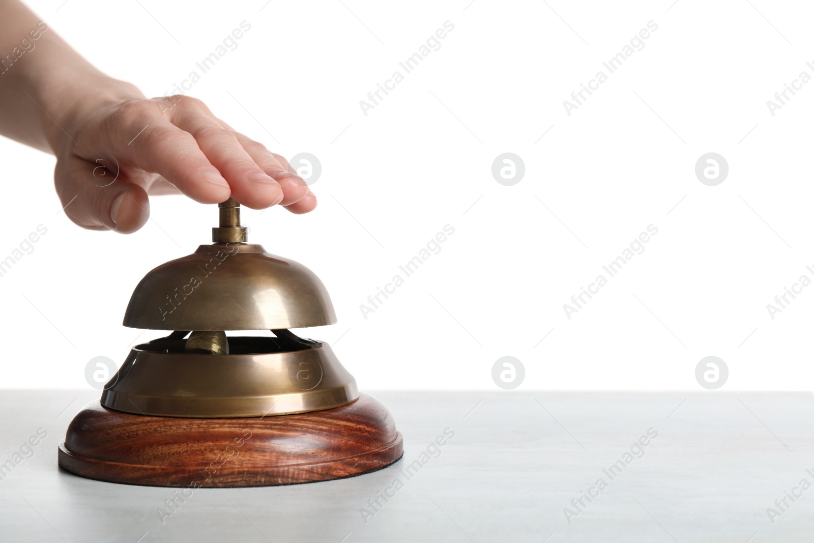 Photo of Man ringing hotel service bell at light table