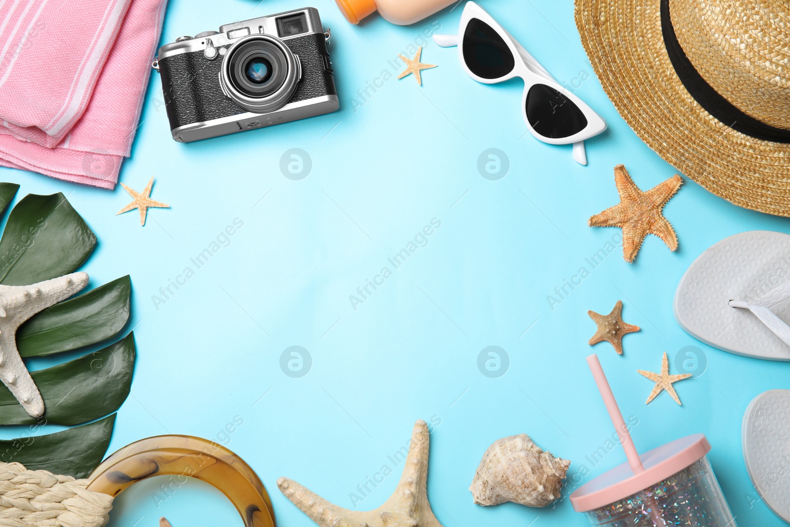 Photo of Flat lay composition with beach objects on light blue background. Space for text