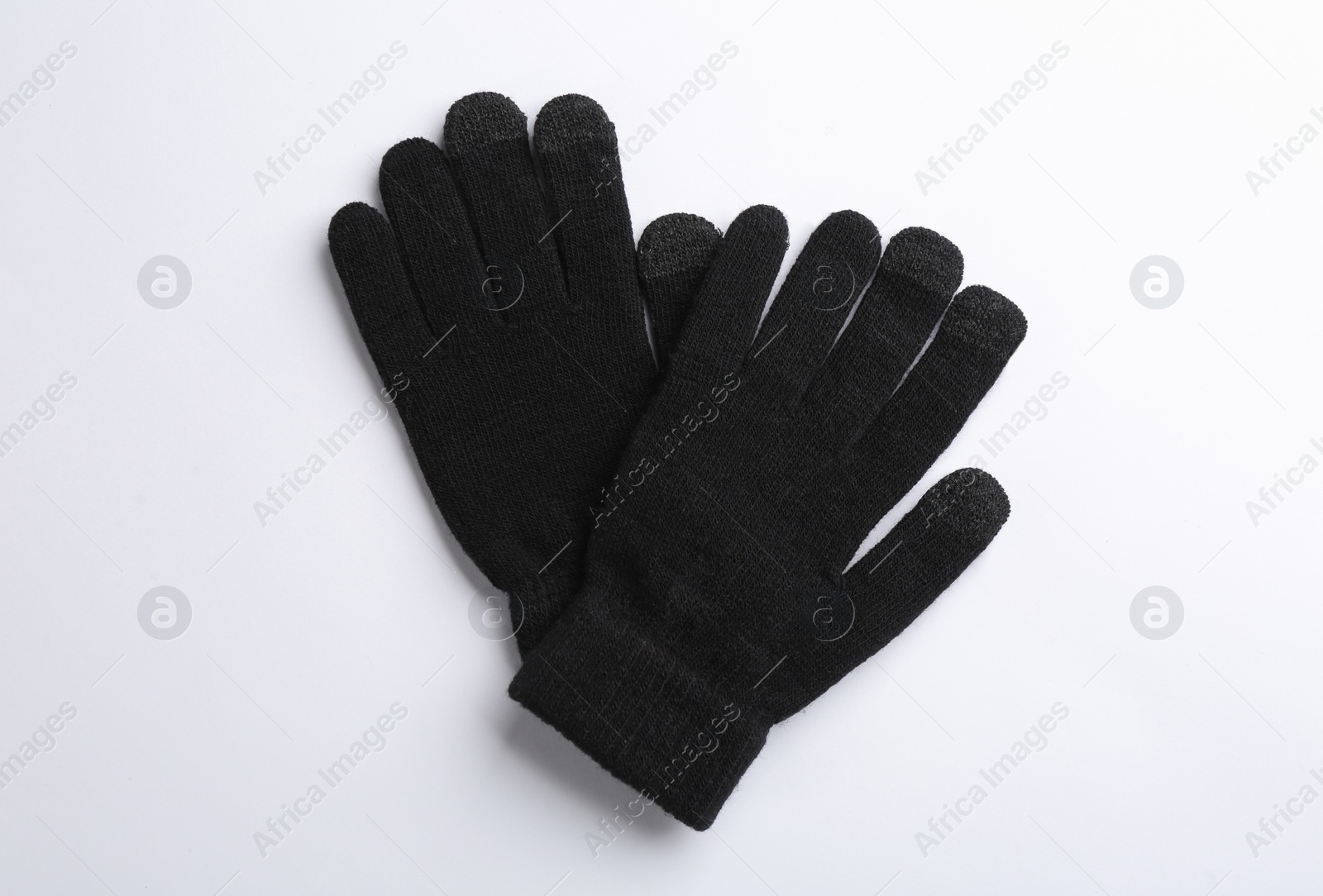 Photo of Pair of stylish woolen gloves on white background, flat lay