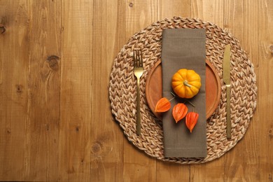 Photo of Autumn table setting, pumpkin and physalis, flat lay. Space for text