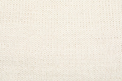 Photo of Texture of cozy warm sweater as background, closeup