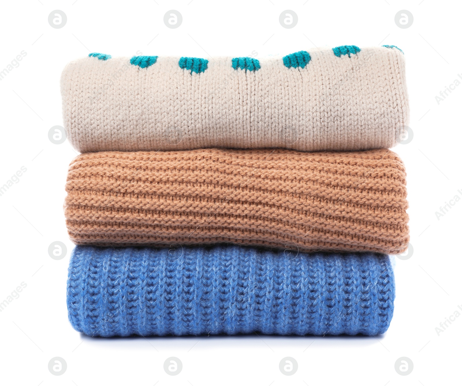 Photo of Stack of folded knitted sweaters on white background