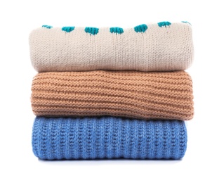 Photo of Stack of folded knitted sweaters on white background