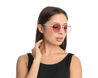 Beautiful young woman wearing sunglasses on white background