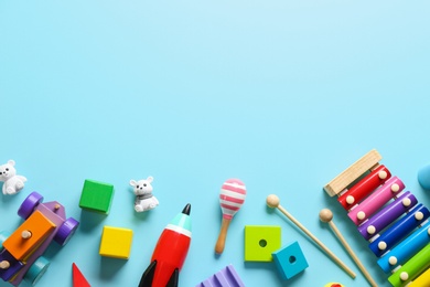 Photo of Flat lay composition with different toys on light blue background. Space for text