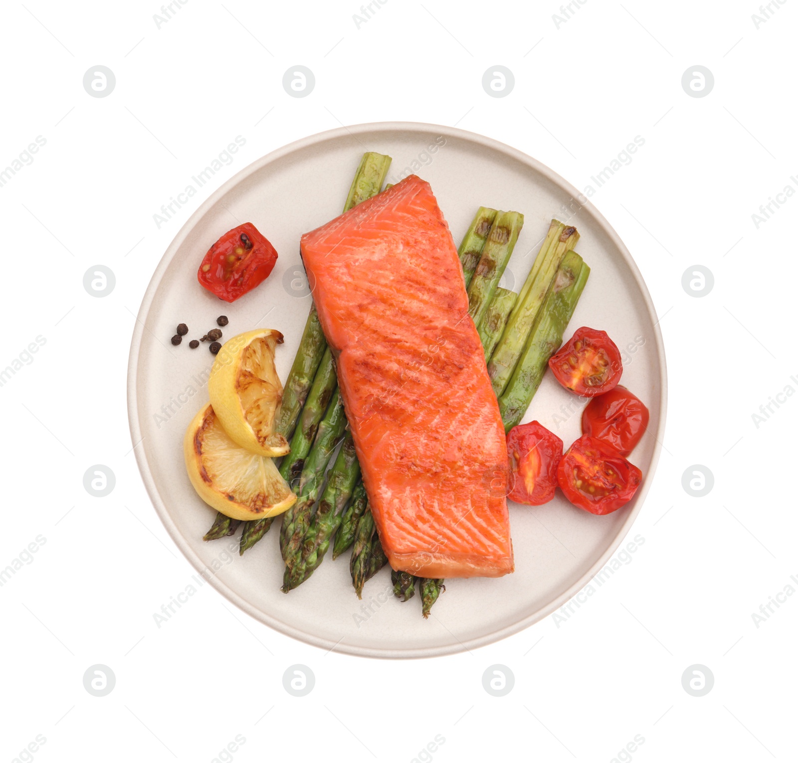 Photo of Tasty grilled salmon with asparagus, tomatoes, spices and lemon isolated on white, top view