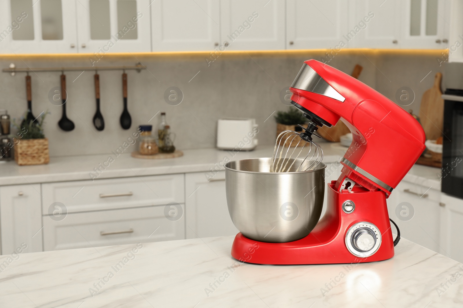 Photo of Modern red stand mixer on white marble table in kitchen, space for text