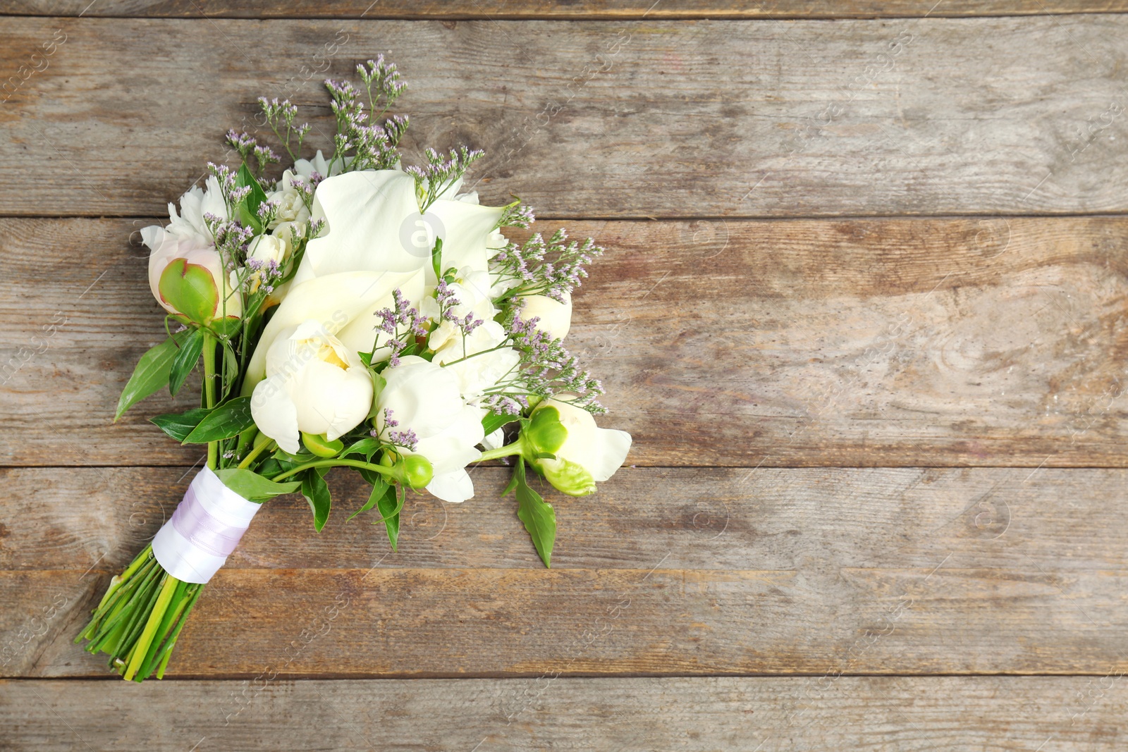 Photo of Bouquet of beautiful fragrant flowers on wooden background