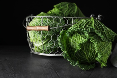 Photo of Fresh ripe savoy cabbages on black table