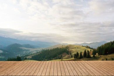 Image of Empty wooden surface and beautiful view of mountain landscape on cloudy day