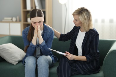 Photo of Psychotherapist working with patient on sofa in office