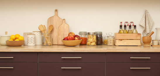 Stylish kitchen interior with wooden countertop and wall cabinets