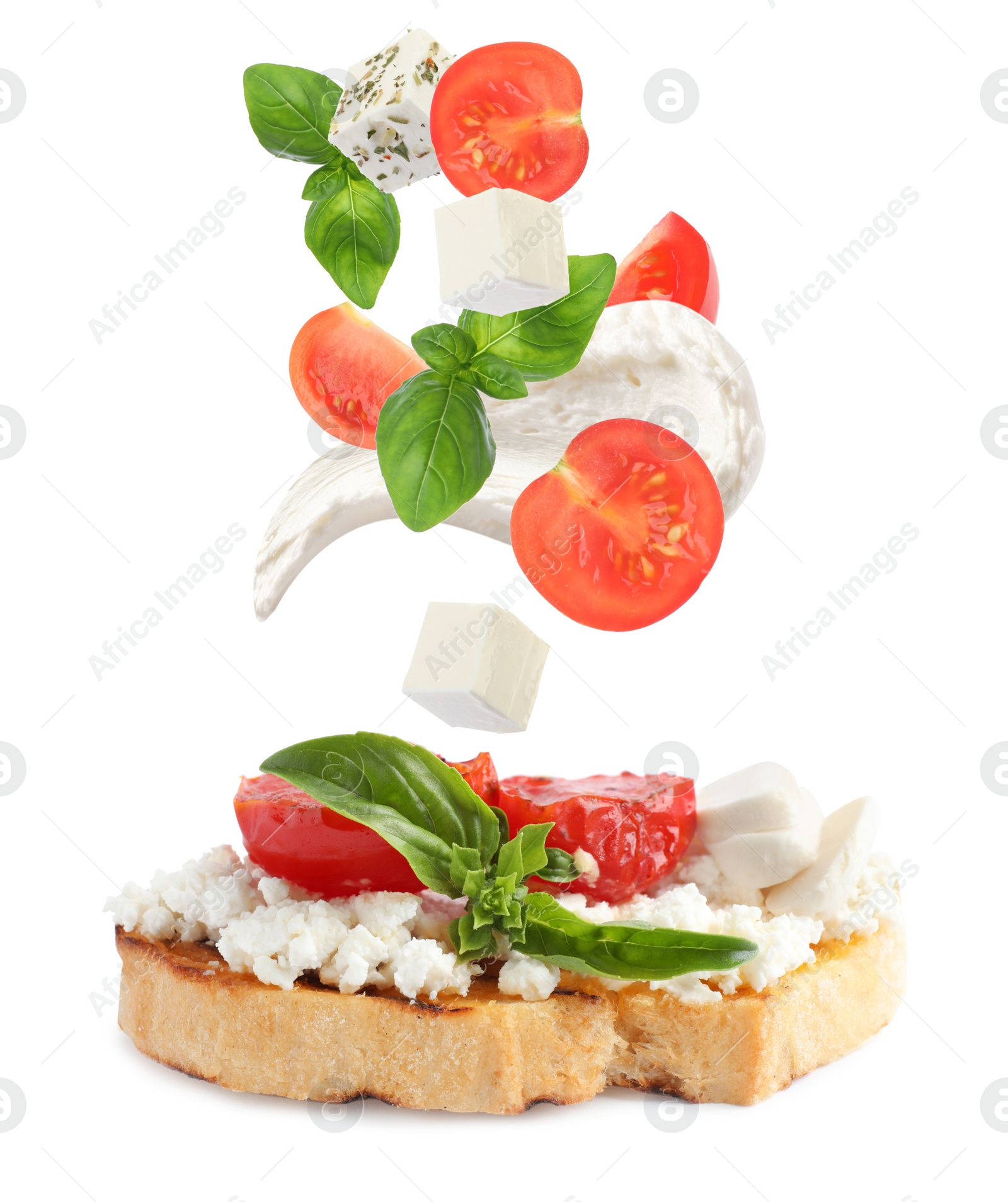 Tasty bruschetta with flying ingredients on white background Image of Tasty bruschetta with flying ingredients on white background