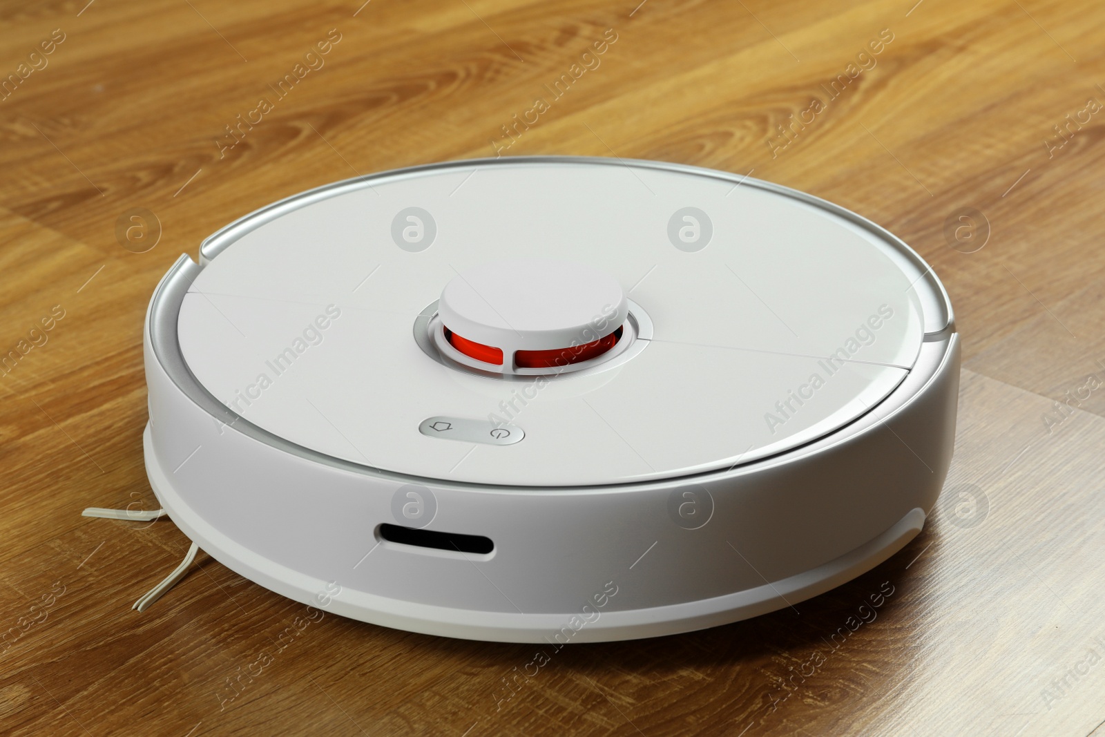 Photo of Modern robotic vacuum cleaner on wooden floor