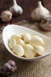 Photo of Fresh garlic cloves and bulbs on table,closeup