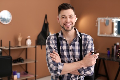 Photo of Professional hairdresser in beauty salon