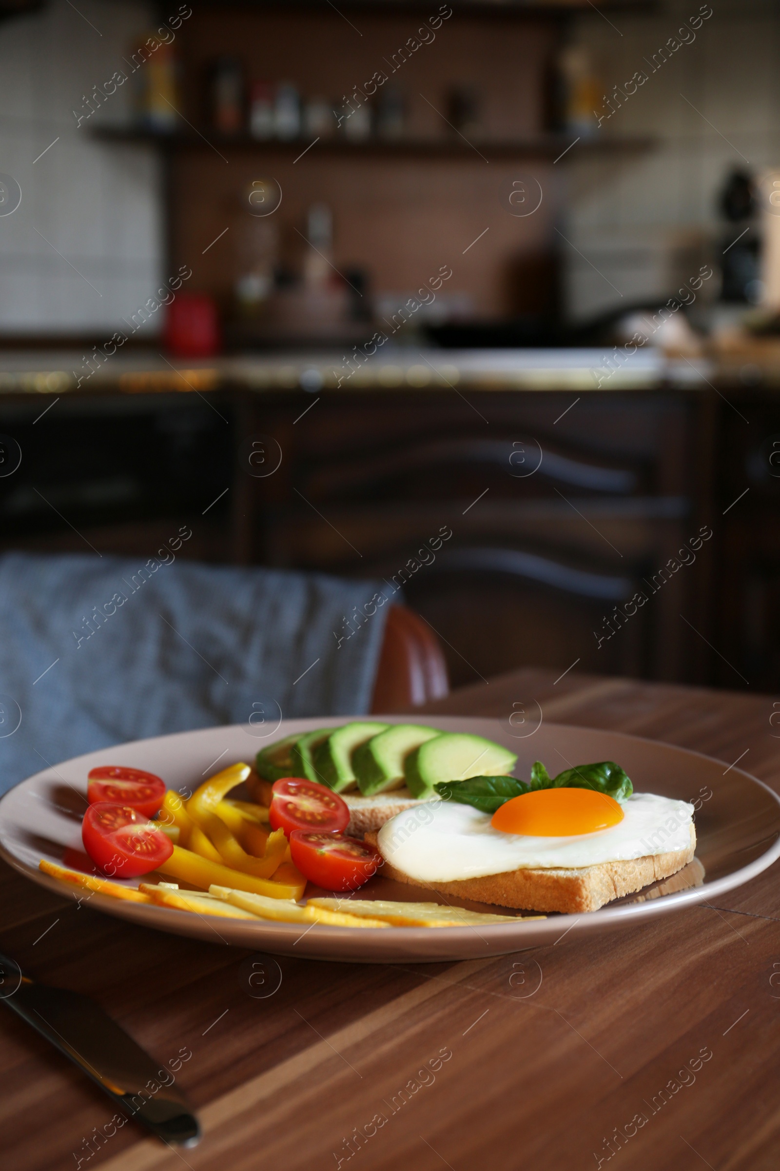 Photo of Tasty toasts with fried egg, avocado, cheese and vegetables on wooden table, closeup
