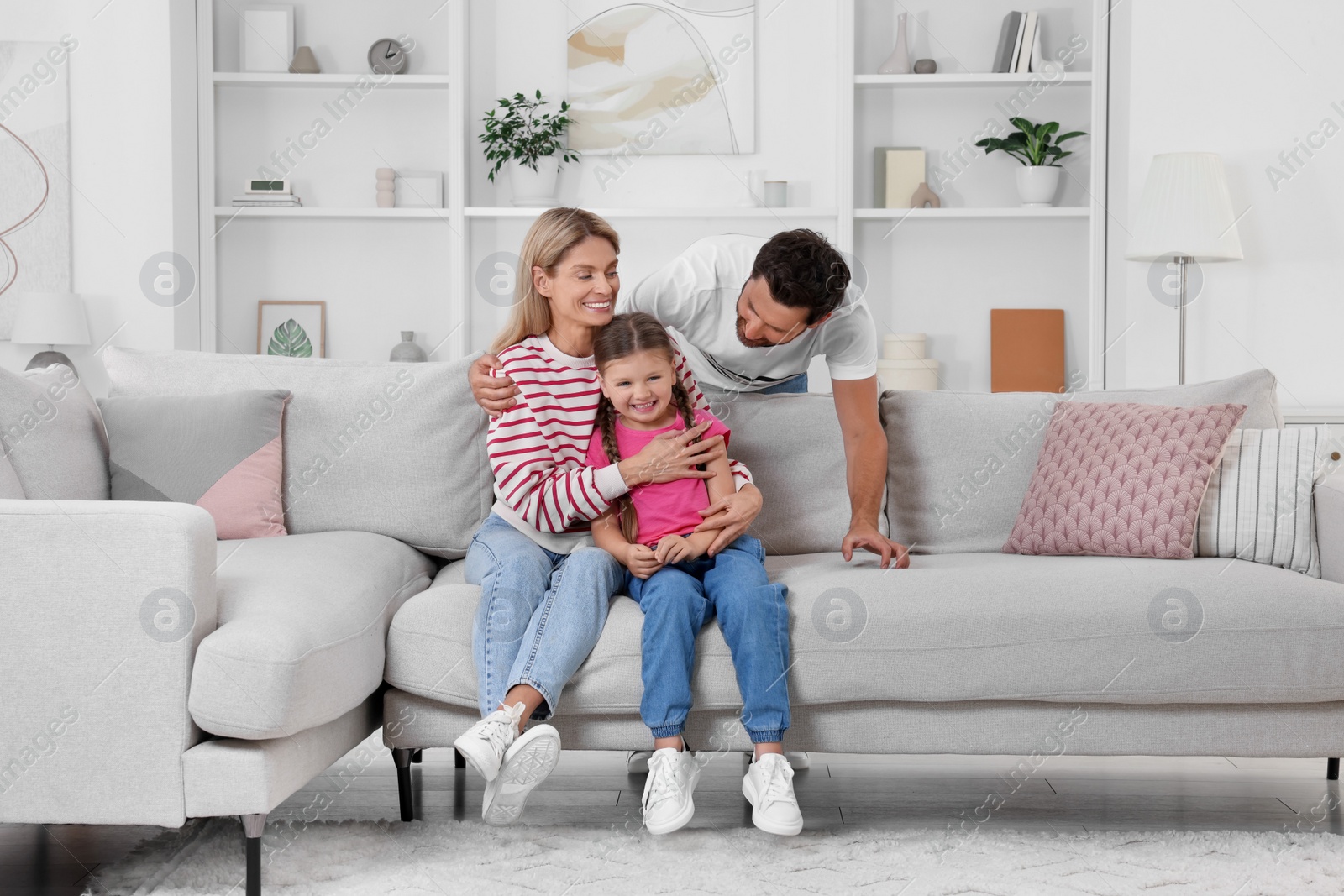 Photo of Happy family having fun together on sofa at home