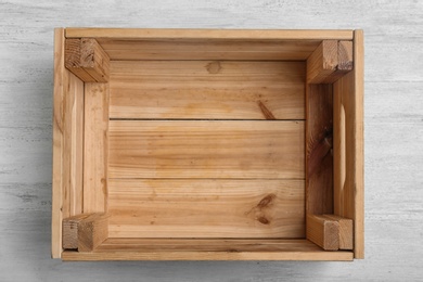 Photo of Empty crate on wooden background, top view