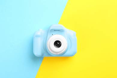 Photo of Light blue toy camera on color background, top view