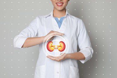 Image of Closeup view of doctor and illustration of kidneys on light grey background