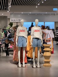Photo of WARSAW, POLAND - JULY 17, 2022: Mango store interior with women clothes in shopping mall