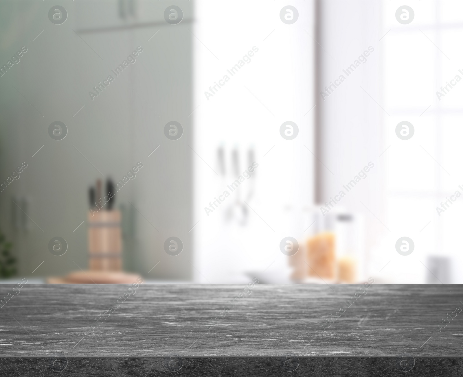 Image of Empty grey stone surface and blurred view of kitchen with modern window 