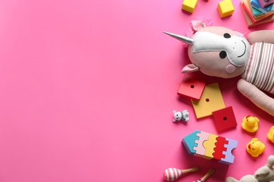 Photo of Flat lay composition with different toys on pink background. Space for text