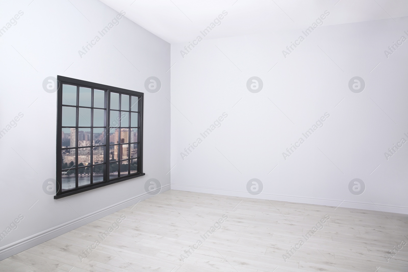 Photo of Parquet floor and wooden window in light empty room