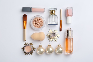 Flat lay composition with decorative cosmetic products on light background. Winter care