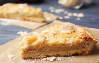 Piece of delicious sweet pear tart on table, closeup