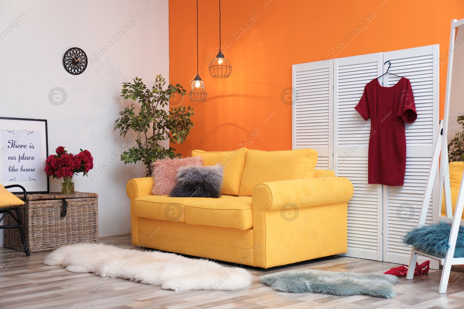 Photo of Elegant living room interior with yellow sofa and folding screen