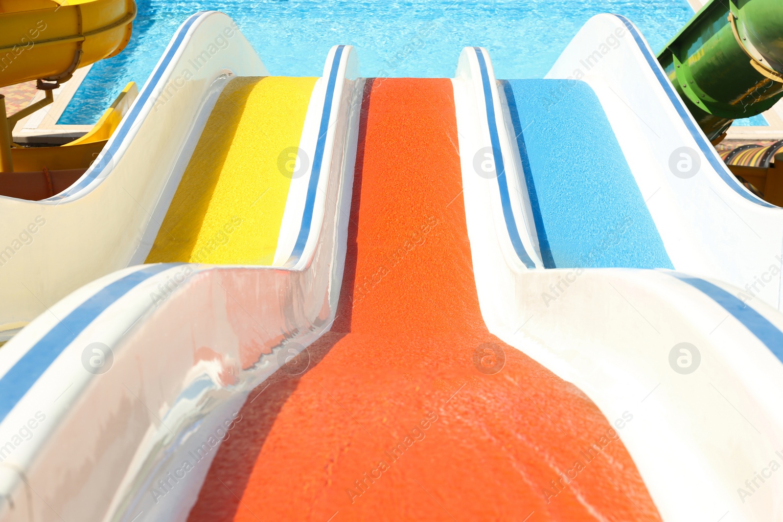 Photo of View from colorful slides in water park on sunny day