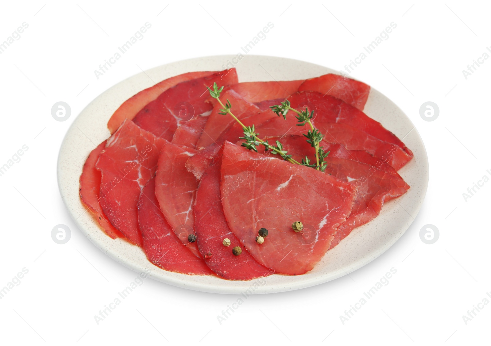 Photo of Slices of tasty bresaola and thyme isolated on white