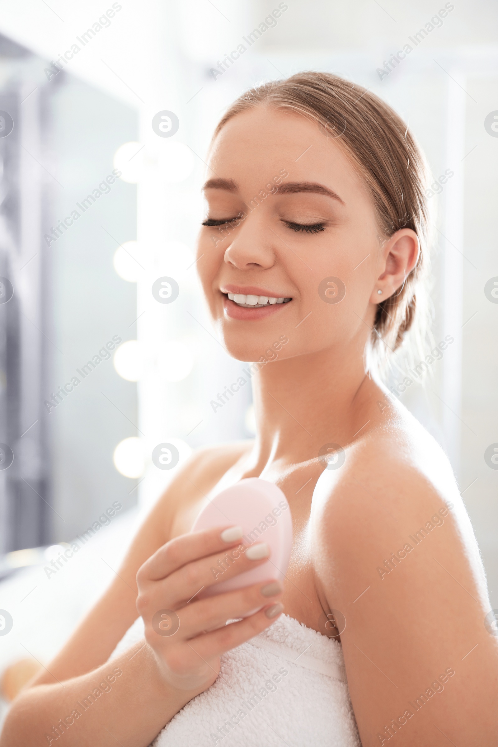 Photo of Young woman with soap bar on blurred background