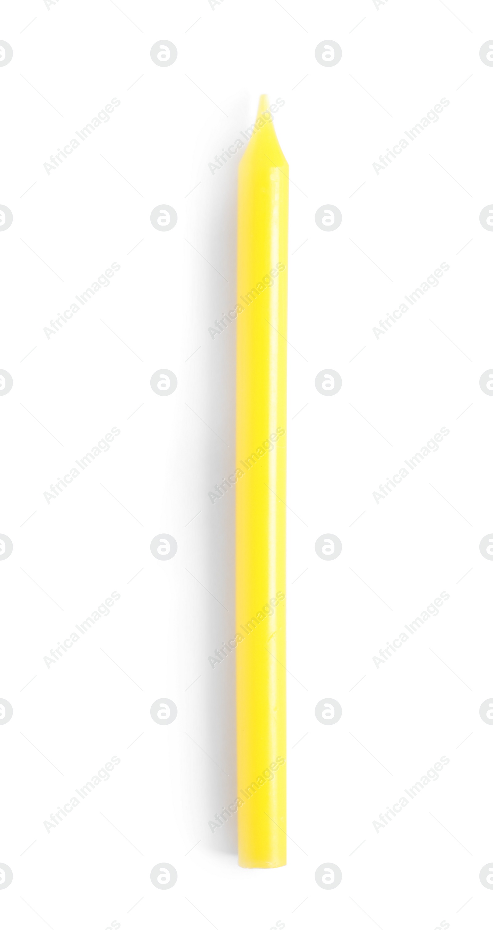 Photo of Yellow birthday candle isolated on white, top view