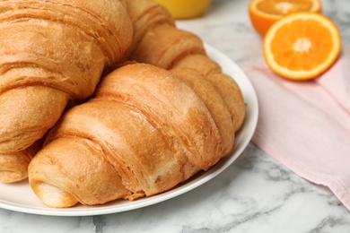 Tasty croissants on plate, closeup