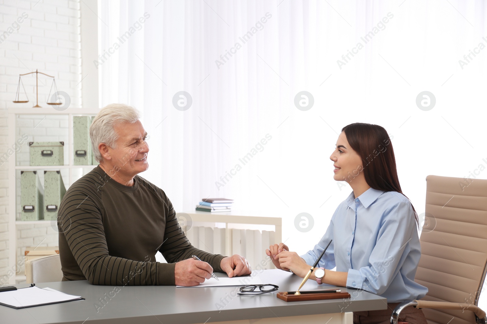 Photo of Lawyer having meeting with client in office